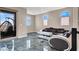 Comfortable living room with a stylish hanging chair, ample natural light, and sleek flooring at 11658 Midnight Melody Ave, Las Vegas, NV 89138
