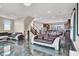 A stylish living room featuring marble-style floors, modern furniture, open floor plan, and natural light at 11658 Midnight Melody Ave, Las Vegas, NV 89138