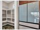 Pantry and modern stainless steel refrigerator, granite countertops, and views of the outdoor scenery at 11658 Midnight Melody Ave, Las Vegas, NV 89138