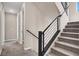 A staircase with carpeted steps and modern black metal railings at 11658 Midnight Melody Ave, Las Vegas, NV 89138