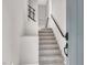 Well-lit stairway with modern black railings, leading to the upper level of the home at 11658 Midnight Melody Ave, Las Vegas, NV 89138