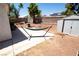 The backyard features a hammock, storage shed, and desert landscaping at 1709 High Breeze Ct, Las Vegas, NV 89106