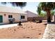 Spacious backyard with space for outdoor entertainment, a fire pit, and some desert landscaping at 1709 High Breeze Ct, Las Vegas, NV 89106