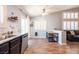 Open kitchen and dining area with modern table, bench, and black cabinets at 1709 High Breeze Ct, Las Vegas, NV 89106