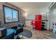 Salon-inspired living space with brick accent wall, wood floors, and eye-catching red retro refrigerator at 1709 High Breeze Ct, Las Vegas, NV 89106