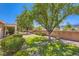 This backyard offers a private retreat with green grass, mature trees, and a charming brick wall at 2085 Joy View Ln, Henderson, NV 89012