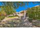 This backyard features a covered patio area and mature trees that offer relaxing shaded areas at 2085 Joy View Ln, Henderson, NV 89012