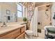 Bright bathroom featuring a shower-tub combination with decorative shower curtain, and updated vanity at 2085 Joy View Ln, Henderson, NV 89012