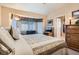 Comfortable bedroom featuring a large window with seating area, and neutral wall-to-wall carpet at 2085 Joy View Ln, Henderson, NV 89012
