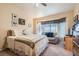 Comfortable bedroom features a large window with a sitting area, ceiling fan, and neutral carpet at 2085 Joy View Ln, Henderson, NV 89012