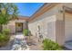 Inviting front entrance with a charming wreath, manicured landscaping, and well-lit pathway at 2085 Joy View Ln, Henderson, NV 89012