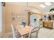 Bright kitchen with white appliances, wood cabinets, tile floors, and adjacent dining area at 2085 Joy View Ln, Henderson, NV 89012