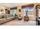 Comfortable living room featuring plush seating, a large window, and built-in bookshelves at 2085 Joy View Ln, Henderson, NV 89012