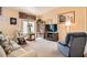 Cozy living room with comfortable seating, a large window, and a well-stocked bookshelf at 2085 Joy View Ln, Henderson, NV 89012