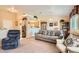 Open-concept living room with neutral tones, plush seating, and views into the adjacent kitchen at 2085 Joy View Ln, Henderson, NV 89012