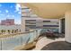 Relax on this private balcony featuring glass railings and a stylish outdoor seating area overlooking the city at 2877 Paradise Rd # 702, Las Vegas, NV 89109