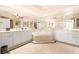 Elegant bathroom featuring a soaking tub, dual vanities, and a mirrored wall at 2877 Paradise Rd # 702, Las Vegas, NV 89109