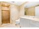 Modern bathroom featuring a walk-in shower and vanity with elegant gold fixtures at 2877 Paradise Rd # 702, Las Vegas, NV 89109