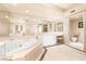 Luxurious bathroom featuring a soaking tub, vanity, and elegant tiled floors at 2877 Paradise Rd # 702, Las Vegas, NV 89109