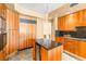 Open kitchen features custom wood cabinetry, granite counters, and stainless steel appliances at 2877 Paradise Rd # 702, Las Vegas, NV 89109