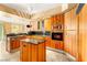 Chef's kitchen with island, granite counters, wooden cabinets and stainless appliances at 2877 Paradise Rd # 702, Las Vegas, NV 89109