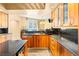 Gourmet kitchen features sleek granite countertops, wood cabinetry, and stainless appliances at 2877 Paradise Rd # 702, Las Vegas, NV 89109