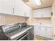 Functional laundry room equipped with washer, dryer, and built-in storage cabinets at 2877 Paradise Rd # 702, Las Vegas, NV 89109