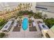 Aerial view of a stunning pool area with cabanas and lounge areas, surrounded by tropical landscaping at 2877 Paradise Rd # 702, Las Vegas, NV 89109