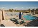 Inviting swimming pool area with lounge chairs, umbrellas, and views of the Las Vegas skyline at 2925 Big Green Ln, Las Vegas, NV 89134