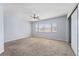 This spacious bedroom features neutral carpet, a ceiling fan, and generous windows for natural light at 3221 Epson St, Las Vegas, NV 89129