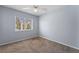 Bedroom featuring carpet flooring, a ceiling fan, and a window offering natural light at 3221 Epson St, Las Vegas, NV 89129