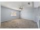 Spacious bedroom with carpet, ceiling fan, and a window offering natural light at 3221 Epson St, Las Vegas, NV 89129