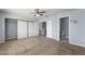 This bedroom features neutral carpet, a ceiling fan, and closet with sliding doors at 3221 Epson St, Las Vegas, NV 89129