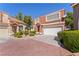 Charming two-story townhome with a tile roof, well-maintained landscaping, and an attached two-car garage at 3221 Epson St, Las Vegas, NV 89129