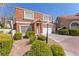 Charming two-story townhome with a tile roof, well-maintained landscaping, and an attached two-car garage at 3221 Epson St, Las Vegas, NV 89129