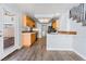 Galley-style kitchen with light wood cabinets and access to backyard at 3221 Epson St, Las Vegas, NV 89129