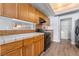 Galley kitchen with wooden cabinets and black gas range at 3221 Epson St, Las Vegas, NV 89129