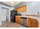 View of kitchen featuring black refrigerator and stainless steel dishwasher at 3221 Epson St, Las Vegas, NV 89129