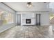 Spacious living room featuring a fireplace, tile floors, and large windows providing ample natural light at 3221 Epson St, Las Vegas, NV 89129