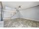 Open-concept living room with staircase, tile flooring, and neutral paint, creating a bright and inviting space at 3221 Epson St, Las Vegas, NV 89129