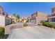 Exterior view of multiple townhomes featuring tile roofs and well-maintained landscaping in a desirable community at 3221 Epson St, Las Vegas, NV 89129