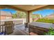 Outdoor patio with hot tub and BBQ grill overlooking the fenced in green backyard at 3709 Corte Bella Hills Ave, North Las Vegas, NV 89081