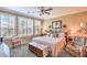 Serene bedroom features large windows, a cozy bed, and a sitting area for relaxation in neutral earth tones at 3709 Corte Bella Hills Ave, North Las Vegas, NV 89081