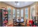 Bright breakfast nook with a round table, lots of natural light, and white plantation shutters for privacy at 3709 Corte Bella Hills Ave, North Las Vegas, NV 89081