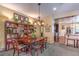 Traditional dining room features dark wood table, chairs, and a full bookshelf for a cozy feel at 3709 Corte Bella Hills Ave, North Las Vegas, NV 89081