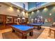 Beautiful game room with two billiard tables under pendant lighting and light blue felt at 3709 Corte Bella Hills Ave, North Las Vegas, NV 89081