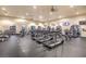 Bright gym area with multiple treadmills and fitness equipment with windows and televisions at 3709 Corte Bella Hills Ave, North Las Vegas, NV 89081