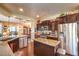 Spacious kitchen featuring stainless steel appliances and dark wood cabinetry at 3709 Corte Bella Hills Ave, North Las Vegas, NV 89081