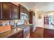 Well-appointed kitchen with stainless steel appliances, granite countertops, and dark wood cabinetry at 3709 Corte Bella Hills Ave, North Las Vegas, NV 89081