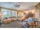 Open-concept living room with a comfortable sectional sofa and ample natural light at 3709 Corte Bella Hills Ave, North Las Vegas, NV 89081